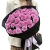 Delicate pink chrysanthemums in black packaging.