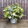 Mixed floral arrangement in a birch-style container with a blue succulent centerpiece