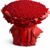 Large bouquet of red roses wrapped in red paper