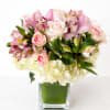 A graceful and romantic arrangement designed in soft blush and ivory tones