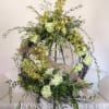 Large circular floral wreath with green orchids and pale green blooms