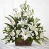 White lilies and carnations in a wicker basket
