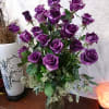 Bouquet of purple roses in a clear glass vase