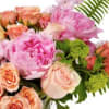 Pastel bouquet with pink peonies and peach roses accented by fern fronds