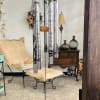 Hanging silver wind chime with black lettering and a round tag