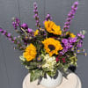 Bring the beauty of summer indoors with our Golden Hour arrangement. Featuring