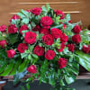 Large arrangement of red roses with broad green foliage