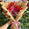 12 Gerberas in a Wrapped Bouquet with Baby Breath Accents. THE COLOR