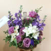 Soft and serene, this artistic array of cream and lavender blooms around