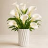Our Modern White Calla Lily Arrangement is a refined floral design featuring