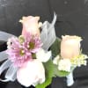 Pale pink and peach roses paired with lavender-pink daisies make these wearable