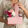 Pink gift box with mixed flowers and a dessert cup