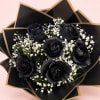 Bouquet of black roses with white baby's breath in black and gold wrap