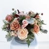 A charming, medium-sized arrangement bursting with sweet blooms and lush greenery in