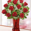 Gorgeous Long stem red roses in a red vase. 