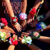 Hands wearing colorful corsages with roses and ribbons