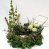 Circular floral wreath with white roses and mixed greenery