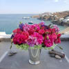 Pink and purple flower arrangement in a silver vase