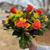 Flowers of yellow and green, and pops of orange and purple. Full