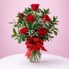 Classic red roses with baby&rsquo;s breath and fresh greenery, arranged in a