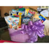 Purple gift basket filled with assorted snack packs and tied with a ribbon