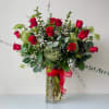24 Premium Freedom roses imported from Ecuador, with greens and fillers. Built