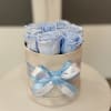 Blue roses arranged in a round hat box with a satin ribbon