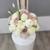 Bouquet of blush and white roses with round white blooms in a vase