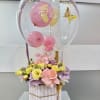 Pink balloon bouquet with flowers in a striped box