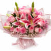 Pink bouquet with lilies and roses wrapped in sheer paper