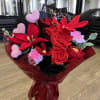 Crocheted red and pink flower bouquet with heart accents and black feathers