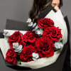 Bouquet of red roses wrapped in black and white paper