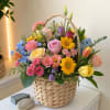 Colorful mixed flower basket with roses, tulips, and daisies
