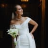 Bride holding a bouquet of white calla lilies