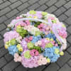 A lush, pastel-filled gift for spring celebrations, this flower arrangement is a