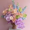 Lavender phalaenopsis orchids set a dreamy tone in this colorful centerpiece, perfect