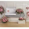 Pink floral funeral casket spray with matching standing arrangements and wreaths