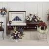 Funeral casket spray and wreath with red, white, and blue flowers