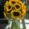 Bouquet of yellow sunflowers in a clear glass vase