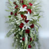 Tall red and white floral spray with lilies and roses