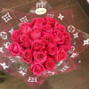 Bouquet of hot pink roses wrapped in clear cellophane with a white patterned design