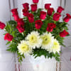 Red roses and white chrysanthemums arranged in a white vase
