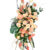 Tall peach and coral floral spray on an easel