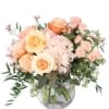 Peach and blush rose bouquet in a clear glass vase