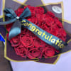 Bouquet of red roses wrapped with a congratulatory ribbon