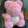 Pink rose teddy bear with a white heart on its chest