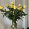 Yellow roses arranged in a clear glass vase