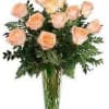 Peach roses arranged in a clear glass vase
