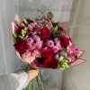 Reds, purples, lavender blooms, including roses, orchids, snaps and more. Hand-tied bouquet.