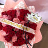 Bouquet of red and pink roses wrapped in pink paper with a congratulations ribbon
